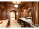 Custom wet bar features beautiful wood cabinetry, granite countertops, and a unique stained glass ceiling at 155 Union Chapel Dr, Mooresville, NC 28117