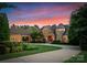 Elegant home with beautiful landscaping, a circular driveway, and a unique turret design at 155 Union Chapel Dr, Mooresville, NC 28117