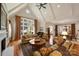 Bright living room with vaulted ceilings, hardwood floors, and large windows overlooking landscaped yard at 155 Union Chapel Dr, Mooresville, NC 28117