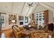 Elegant living room with vaulted ceilings, custom bookshelves, a fireplace, and hardwood floors at 155 Union Chapel Dr, Mooresville, NC 28117