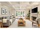 Bright living room with fireplace, coffered ceilings, hardwood floors, and French doors to the outside patio at 155 Union Chapel Dr, Mooresville, NC 28117