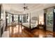 Spacious main bedroom featuring tray ceilings, hardwood floors, and sun-filled sitting area at 155 Union Chapel Dr, Mooresville, NC 28117