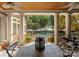Covered patio with stone columns overlooking pool and lake views, perfect for outdoor dining at 155 Union Chapel Dr, Mooresville, NC 28117