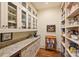 Walk-in pantry featuring custom shelves, cabinetry, granite countertop and hardwood floors at 155 Union Chapel Dr, Mooresville, NC 28117