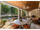 Covered patio with fireplace overlooks a beautiful pool and lake at 155 Union Chapel Dr, Mooresville, NC 28117