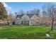 Charming two-story home with a well-manicured lawn, stone accents, and inviting front porch in a wooded area at 1813 Wedowee Ct, Rock Hill, SC 29732