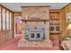 Rustic brick fireplace with a wood-burning stove, adding warmth and charm at 3015 Pageland Hwy, Lancaster, SC 29720