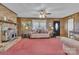 Bright living room with wood-paneled walls and a wood-burning stove at 3015 Pageland Hwy, Lancaster, SC 29720