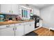 A cozy kitchen features wood counters, white cabinets and black appliances at 3021 Tryon Courthouse Rd, Bessemer City, NC 28016