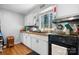 Cozy kitchen featuring wood counters, white cabinets and black appliances at 3021 Tryon Courthouse Rd, Bessemer City, NC 28016