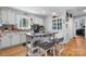 Lovely kitchen showcasing a center island with seating, wood floors, and white cabinets at 3021 Tryon Courthouse Rd, Bessemer City, NC 28016