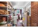 Large laundry room with shelving, washer, dryer and water heater at 3021 Tryon Courthouse Rd, Bessemer City, NC 28016