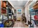 Open mud room with brick accent wall, wood-look floors and black metal shelving units at 3021 Tryon Courthouse Rd, Bessemer City, NC 28016