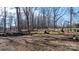 Expansive wooded land with felled logs, highlighting the property's natural and undeveloped state at 3021 Tryon Courthouse Rd, Bessemer City, NC 28016