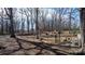 Wooded property featuring a rustic fence and logs, showcasing the natural landscape at 3021 Tryon Courthouse Rd, Bessemer City, NC 28016