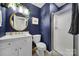 Stylish bathroom showcasing blue walls, modern vanity, and a glass-enclosed shower at 3515 Woodleaf Rd, Charlotte, NC 28205