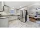 Modern kitchen featuring white cabinets, stainless steel appliances, granite countertops, and tile flooring at 3515 Woodleaf Rd, Charlotte, NC 28205