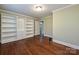 Bedroom with hardwood floors and extensive built-in shelving at 3729 Carmel Acres Dr, Charlotte, NC 28226