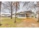 View of backyard with mature trees, a lush lawn, and a screened-in porch at 4648 Madeline Dr, Rock Hill, SC 29732
