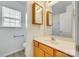 Bathroom vanity features a cream sink, a wood cabinet, and a large framed mirror at 4648 Madeline Dr, Rock Hill, SC 29732