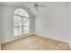 This bedroom is naturally lit with a large arched window and also features wood-look flooring at 4648 Madeline Dr, Rock Hill, SC 29732