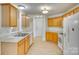 Functional kitchen with bright wood cabinets, white appliances, and ample counter space at 4648 Madeline Dr, Rock Hill, SC 29732