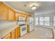 Well-lit kitchen showcasing wood cabinets, white appliances, and an open layout at 4648 Madeline Dr, Rock Hill, SC 29732