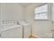 A bright laundry room features a window with a front-loading washer and dryer set at 4648 Madeline Dr, Rock Hill, SC 29732