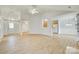 Spacious living room with wood-look floors and access to the kitchen and entryway at 4648 Madeline Dr, Rock Hill, SC 29732