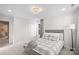 Cozy bedroom with gray bedding and access to another room at 4916 Abendego Rd, Charlotte, NC 28213