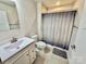 Standard bathroom featuring a shower-tub combo, single sink vanity, and neutral tile flooring at 505 Grandiflora Ave, Lancaster, SC 29720