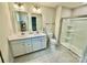 Modern bathroom with double sinks, glass shower, white cabinets, and tile flooring at 505 Grandiflora Ave, Lancaster, SC 29720