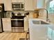 Modern kitchen with stainless steel appliances, white cabinets, quartz countertops, and luxury fixtures at 505 Grandiflora Ave, Lancaster, SC 29720