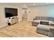 Spacious living room with luxury vinyl flooring, a large sectional, and a mounted flat-screen television at 505 Grandiflora Ave, Lancaster, SC 29720