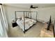 Spacious main bedroom with a black four-poster bed, ceiling fan, neutral carpet, and modern decor at 505 Grandiflora Ave, Lancaster, SC 29720