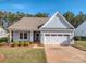 Nice curb appeal! Light blue house with 2 car garage and landscaping at 5220 Admirals Lndg, Lancaster, SC 29720