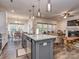 Open concept kitchen with island, granite counters, and views into the living room at 5220 Admirals Lndg, Lancaster, SC 29720