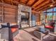 Cozy screened porch with stone fireplace and wicker furniture at 5220 Admirals Lndg, Lancaster, SC 29720