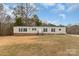 Tan mobile home with brick skirting, dark shutters, and a large yard at 532 Ernest Wright Rd, Lancaster, SC 29720