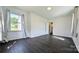 Well-lit bedroom featuring dark hardwood floors and a window at 556 6Th St, Chester, SC 29706