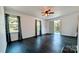 Living room with dark hardwood floors, windows and door to porch at 556 6Th St, Chester, SC 29706