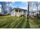 House's backyard with grassy area and surrounding trees at 5618 Pine St, Charlotte, NC 28269