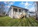Home's backyard, featuring a wooden deck and stairs at 5618 Pine St, Charlotte, NC 28269