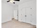 Spacious bedroom with double doors and ceiling fan at 5618 Pine St, Charlotte, NC 28269