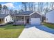 Gray exterior home with white garage door and brick accents at 5618 Pine St, Charlotte, NC 28269