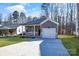 Newly constructed home with gray siding, brick, and a white garage door at 5618 Pine St, Charlotte, NC 28269