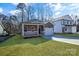 New construction home with gray siding, white garage, and a grassy yard at 5618 Pine St, Charlotte, NC 28269