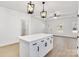 Spacious kitchen island with white cabinets and a quartz countertop at 5618 Pine St, Charlotte, NC 28269