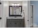 Bathroom features granite countertop, gray vanity, and a large mirror at 582 Barber Loop, Mooresville, NC 28117