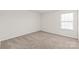 Bright bedroom featuring neutral carpet and a large window at 7324 Teague Dr, Gastonia, NC 28056